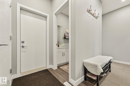 Corridor with baseboards and wood finished floors - 74 Royal Street, St. Albert, AB - Indoor Photo Showing Other Room
