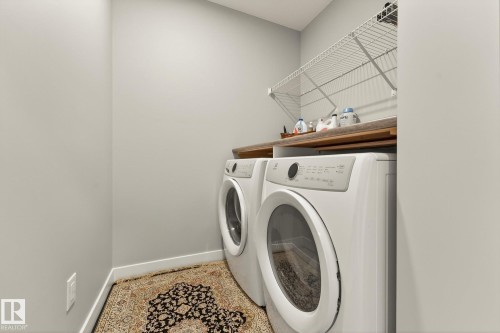 Laundry area with baseboards and washing machine and clothes dryer - 74 Royal Street, St. Albert, AB - Indoor Photo Showing Laundry Room