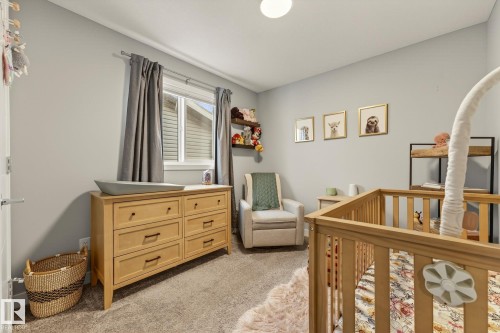 Bedroom featuring light colored carpet and a nursery area - 74 Royal Street, St. Albert, AB - Indoor Photo Showing Bedroom