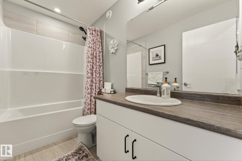 Bathroom featuring vanity and shower / bathtub combination with curtain - 74 Royal Street, St. Albert, AB - Indoor Photo Showing Bathroom