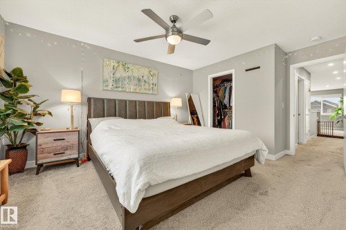 Bedroom with light colored carpet, a spacious closet, and ceiling fan - 74 Royal Street, St. Albert, AB - Indoor Photo Showing Bedroom