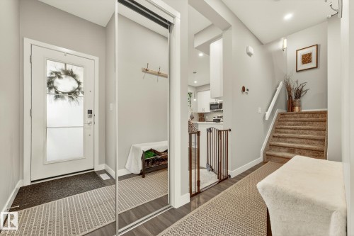 Foyer entrance with dark wood-style flooring and recessed lighting - 74 Royal Street, St. Albert, AB - Indoor Photo Showing Other Room
