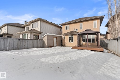 Snow covered house featuring a gazebo, a fenced backyard, stucco siding, a deck, and a storage shed - 10655 181 Avenue, Edmonton, AB - Outdoor