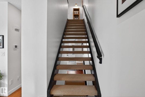 Stairs featuring wood finished floors - 1 9561 143 Street Nw, Edmonton, AB - Indoor Photo Showing Other Room