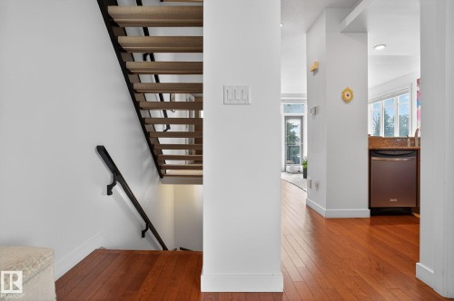 Stairs featuring baseboards and hardwood / wood-style flooring - 1 9561 143 Street Nw, Edmonton, AB - Indoor Photo Showing Other Room