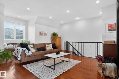Living room with dark wood-style floors, recessed lighting, and vaulted ceiling - 1 9561 143 Street Nw, Edmonton, AB - Indoor Photo Showing Living Room