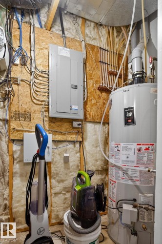 Utility room with gas water heater and electric panel - 1 9561 143 Street Nw, Edmonton, AB - Indoor Photo Showing Basement