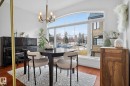 Dining area featuring wood finished floors, hanging lights, and lofted ceiling - 1 9561 143 Street Nw, Edmonton, AB  - Indoor Photo Showing Dining Room 