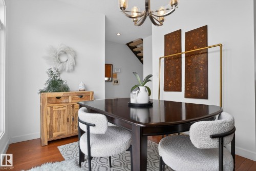 Dining room featuring hanging lights and hardwood / wood-style flooring - 1 9561 143 Street Nw, Edmonton, AB - Indoor