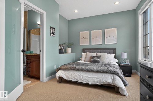 Bedroom with light colored carpet, connected bathroom, and recessed lighting - 1 9561 143 Street Nw, Edmonton, AB - Indoor Photo Showing Bedroom