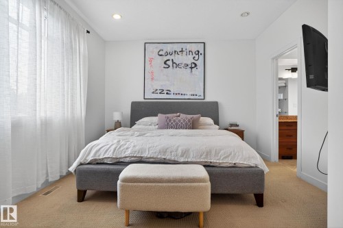 Carpeted bedroom with recessed lighting and connected bathroom - 1 9561 143 Street Nw, Edmonton, AB - Indoor Photo Showing Bedroom