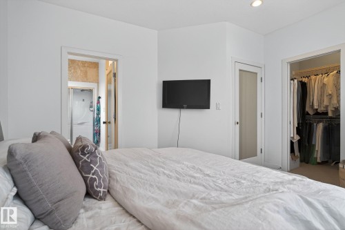 Bedroom featuring a spacious closet and ensuite bathroom - 1 9561 143 Street Nw, Edmonton, AB - Indoor Photo Showing Bedroom