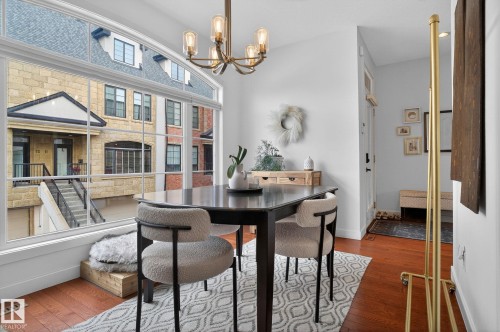 Dining room with hardwood / wood-style flooring and suspended lighting - 1 9561 143 Street Nw, Edmonton, AB - Indoor Photo Showing Dining Room