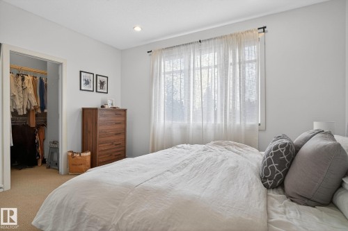 Bedroom with carpet, a walk in closet, and recessed lighting - 1 9561 143 Street Nw, Edmonton, AB - Indoor Photo Showing Bedroom