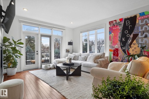 Living area featuring wood finished floors and recessed lighting - 1 9561 143 Street Nw, Edmonton, AB - Indoor Photo Showing Living Room