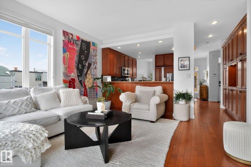 Living area with light wood-style flooring and recessed lighting - 1 9561 143 Street Nw, Edmonton, AB - Indoor Photo Showing Living Room