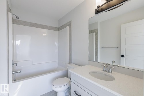 Bathroom featuring vanity and tub / shower combination - 90 Dansereau Way N, Beaumont, AB - Indoor Photo Showing Bathroom