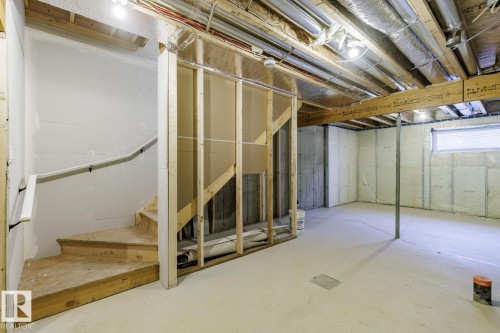 Unfinished basement featuring stairway - 90 Dansereau Way N, Beaumont, AB - Indoor Photo Showing Basement