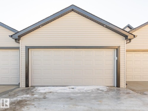 Garage featuring driveway - 90 Dansereau Way N, Beaumont, AB - Outdoor With Exterior