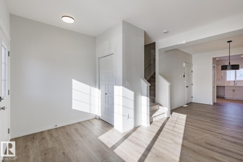 Foyer featuring stairs and light wood-style floors - 90 Dansereau Way N, Beaumont, AB - Indoor Photo Showing Other Room