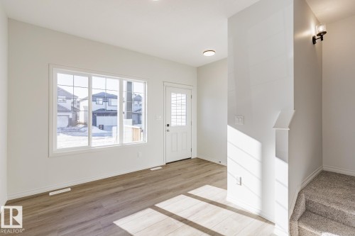 Foyer featuring light wood finished floors and baseboards - 90 Dansereau Way N, Beaumont, AB - Indoor Photo Showing Other Room