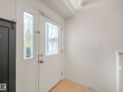 Entryway with light tile patterned floors and baseboards - 