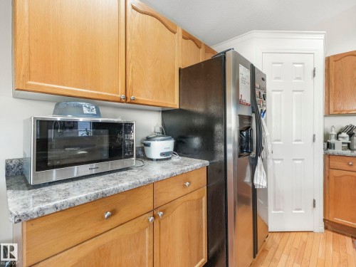 Kitchen featuring stainless steel appliances and light wood-type flooring - 3239 21 Street, Edmonton, AB - Indoor Photo Showing Kitchen