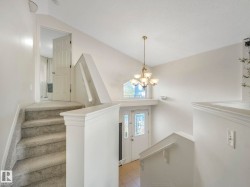 Staircase with hanging lights and tile patterned flooring - 