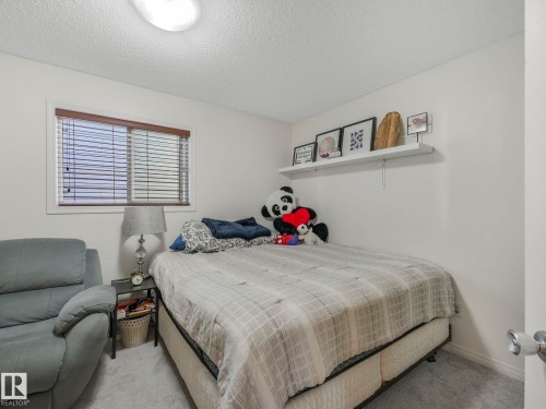 Bedroom with a textured ceiling and carpet floors - 3239 21 Street, Edmonton, AB - Indoor Photo Showing Bedroom