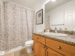 Bathroom with vanity, light tile patterned floors, and shower / bath combo - 