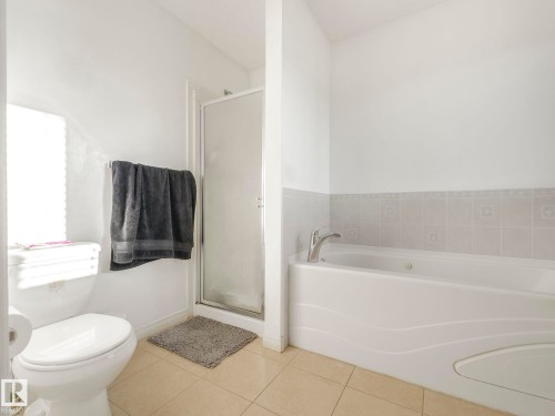 Full bath with a shower stall, tile patterned floors, and a garden tub - 3239 21 Street, Edmonton, AB - Indoor Photo Showing Bathroom
