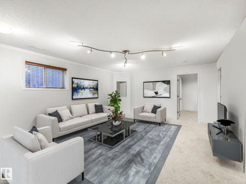 Living room with light colored carpet and a textured ceiling - 3239 21 Street, Edmonton, AB - Indoor Photo Showing Living Room