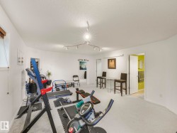 Workout area with a textured ceiling and light carpet - 