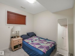 Carpeted bedroom with a textured ceiling and baseboards - 