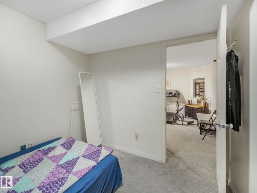 Bedroom featuring light carpet and baseboards - 3239 21 Street, Edmonton, AB - Indoor Photo Showing Bedroom