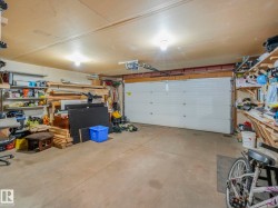 Garage featuring a workshop area and a garage door opener - 