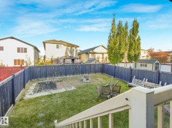 Fenced backyard featuring a residential view and a patio - 