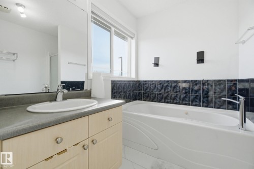 Full bathroom with vanity, a garden tub, and a shower with door - 3248 22 Street, Edmonton, AB - Indoor Photo Showing Bathroom