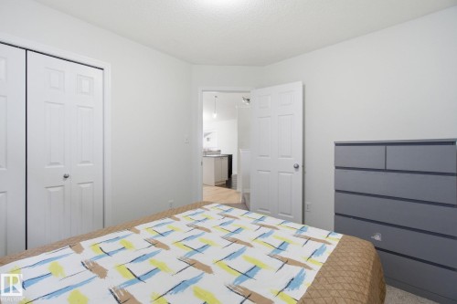 Bedroom with a closet and light carpet - 3248 22 Street, Edmonton, AB - Indoor Photo Showing Bedroom
