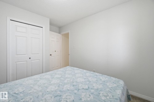Carpeted bedroom with a closet and baseboards - 3248 22 Street, Edmonton, AB - Indoor Photo Showing Bedroom