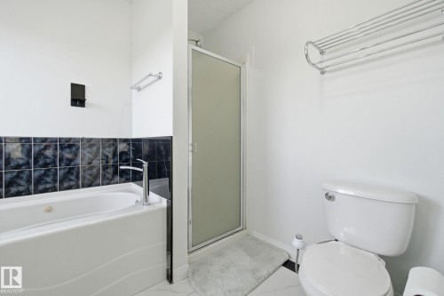 Full bathroom with a stall shower and a bath - 3248 22 Street, Edmonton, AB - Indoor Photo Showing Bathroom