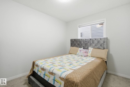 Bedroom featuring baseboards and carpet flooring - 3248 22 Street, Edmonton, AB - Indoor Photo Showing Bedroom