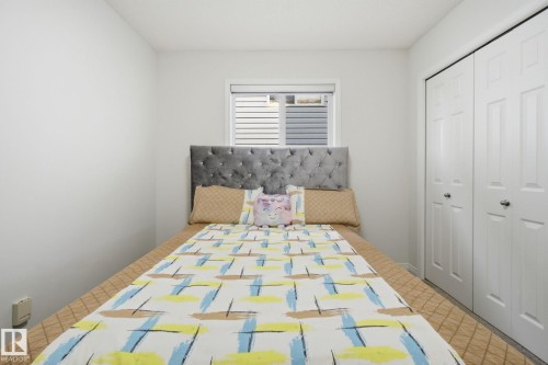 Bedroom with a closet and tile patterned floors - 3248 22 Street, Edmonton, AB - Indoor Photo Showing Bedroom
