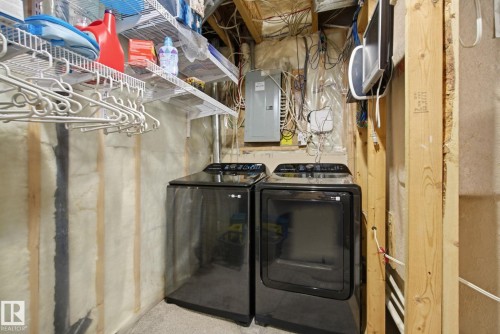 Laundry area with electric panel and washer and dryer - 3248 22 Street, Edmonton, AB - Indoor Photo Showing Laundry Room
