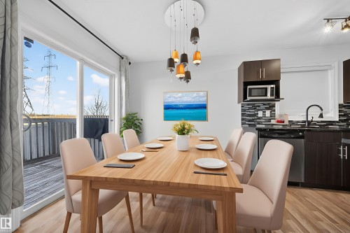 Dining room featuring light wood-style floors and a chandelier - 5212 1A Avenue, Edmonton, AB - Indoor Photo Showing Dining Room