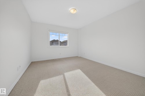Carpeted empty room with baseboards - 5212 1A Avenue, Edmonton, AB - Indoor Photo Showing Other Room