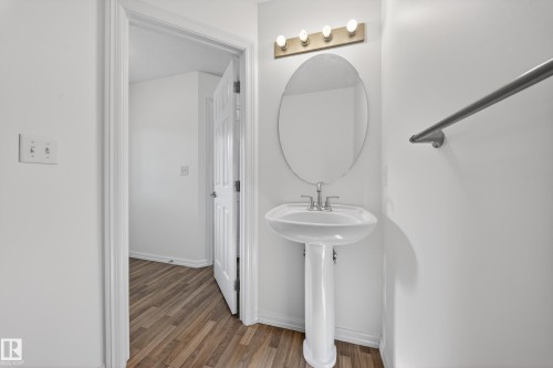 Bathroom featuring wood finished floors and baseboards - 5212 1A Avenue, Edmonton, AB - Indoor Photo Showing Bathroom