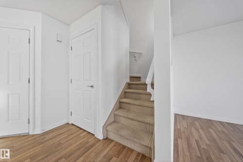 Staircase featuring wood finished floors - 5212 1A Avenue, Edmonton, AB - Indoor Photo Showing Other Room