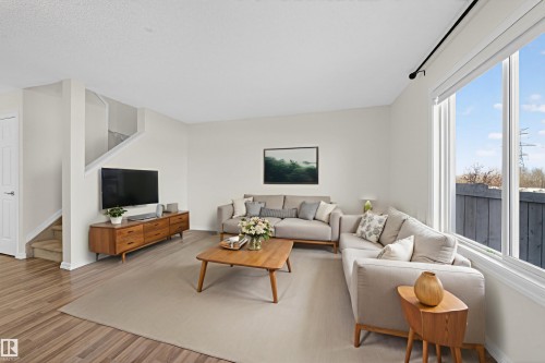Living area featuring stairway and light wood-type flooring - 5212 1A Avenue, Edmonton, AB - Indoor Photo Showing Living Room