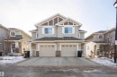 Craftsman-style home with stone siding, driveway, and an attached garage - 13 5317 3 Avenue, Edmonton, AB  - Outdoor With Facade 